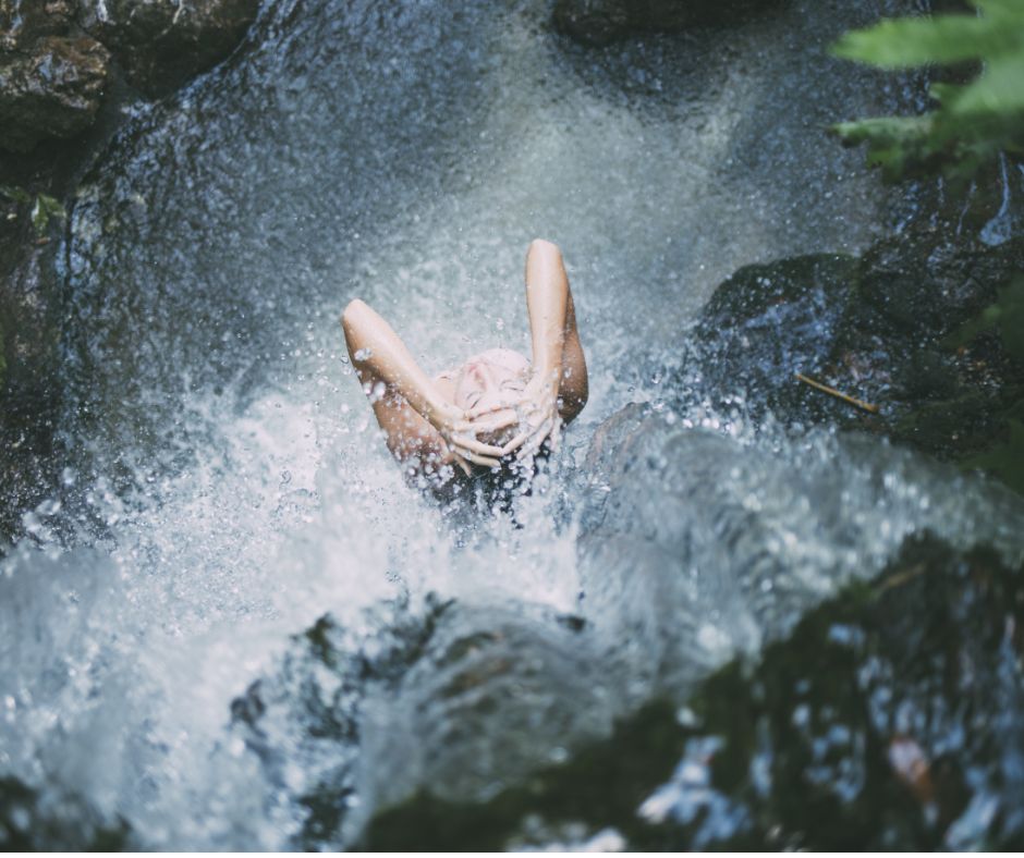 woman showering at a waterfall