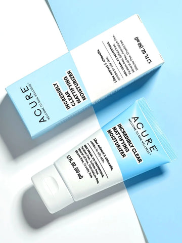 A tube of ACURE Incredibly Clear Mattifying Moisturizer  with its packaging box displayed against a blue & white background.