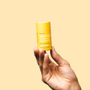 Australian-made Woohoo MELLOW Vegan cruelty-free Natural Deodorant Stick 60g being held in a hand on a light yellow background.  Works all day long - NO Body odour & NO irritation.  