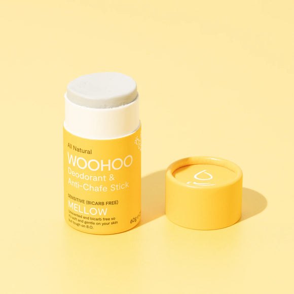 Image of opened Mellow Natural Bicarb-free Deodorant Stick with cardboard cap next to the product on a light yellow background
