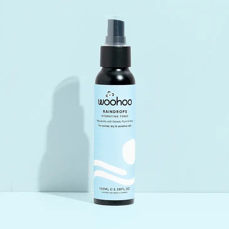 Image of the Woohoo Raindrops Hydrating Tonic bottle with mister on a light blue background
