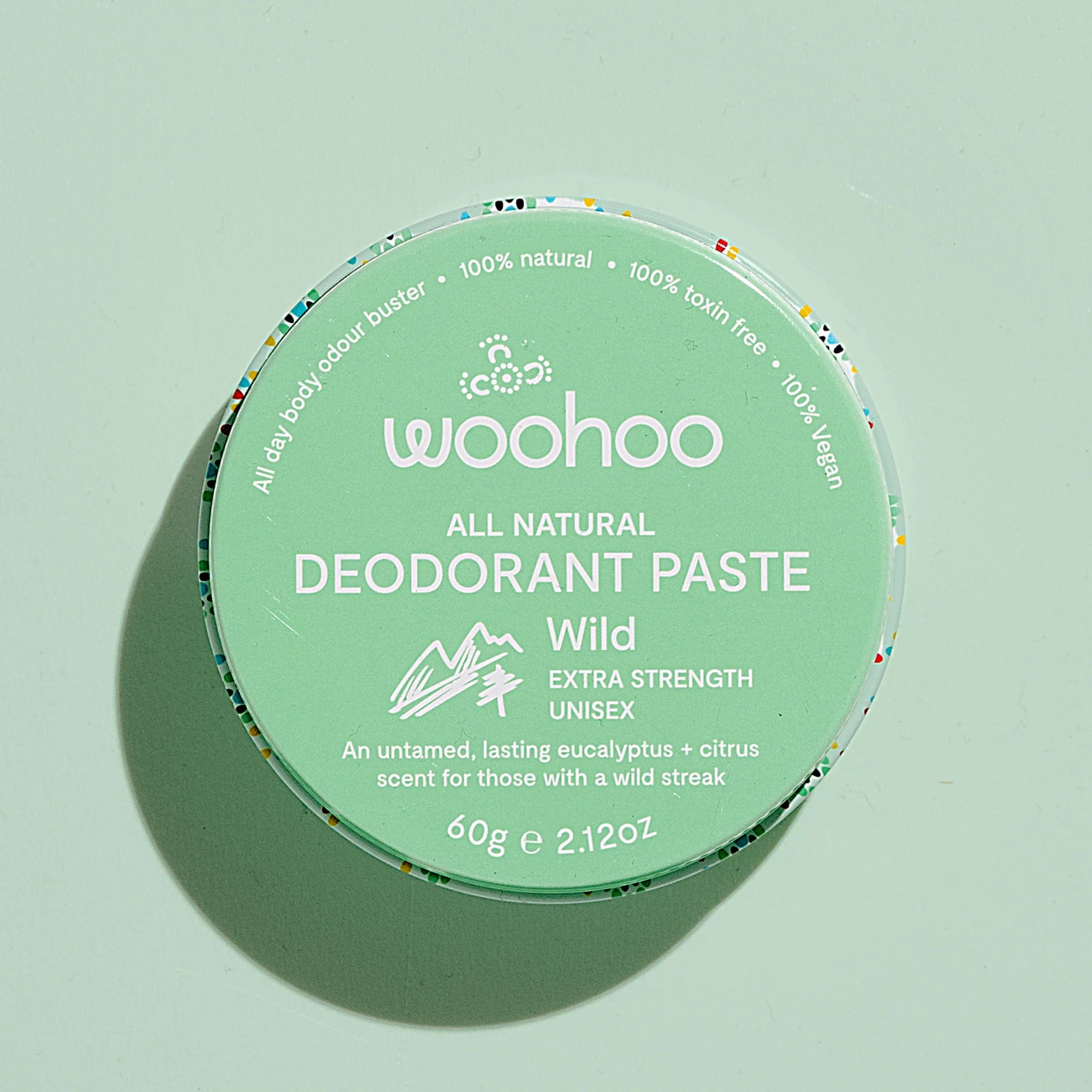 Image of the Woohoo Wild Natural Deodorant Paste tin on a light green background