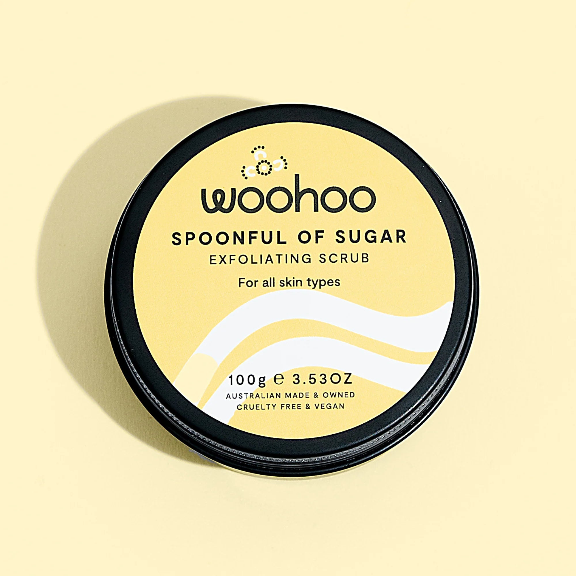 Image of the Woohoo Spoonful of Sugar Exfoliating Scrub tin on a yellow background