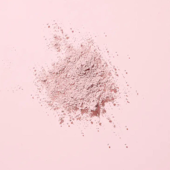 Image of the Woohoo Pig-In-Mud Mineral Mask powder on a pink background 