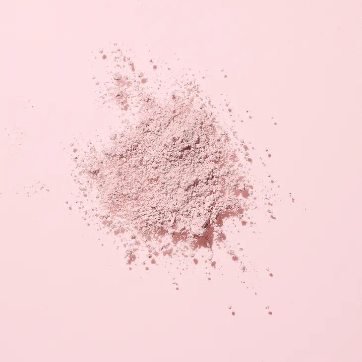 Image of the Woohoo Pig-In-Mud Mineral Mask powder on a pink background 