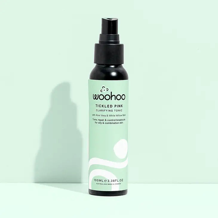 Image of the Woohoo Tickled Pink Clarifying Tonic bottle with mister on a light green background